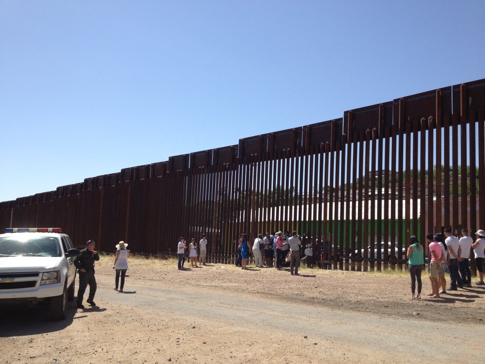 U.S. Border Patrol observes a bittersweet reunion through the U.S.-Mexico fence between DACA recipients and parents who've been deported, New Mexico, U.S., June 11, 2013. (Shutterstock Photo)