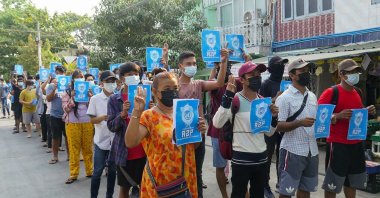 Protesters hold signs relating to "R2P," or the "Responsibility to Protect" principle that the international community should take action against a state that has failed to protect its population, in Yangon's Thaketa township, Myanmar, April 1, 2021. (AFP Photo)