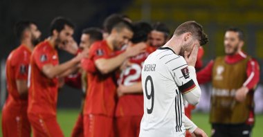 North Macedonia players celebrate as Germany's forward Timo Werner walks past after the FIFA World Cup Qatar 2022 qualification Group J match in Duisburg, western Germany, March 31, 2021. (AFP Photo)