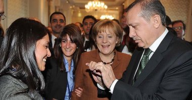 Then-Prime Minister Recep Tayyip Erdoğan (R) breaks a cigarette as he tries to convince a smoker (L) to quit, in Istanbul, Turkey, March 31, 2010. (AA PHOTO)