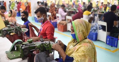 Ruma (R) works in a garment factory in Gazipur, Bangladesh, March 15, 2021. (AFP Photo)