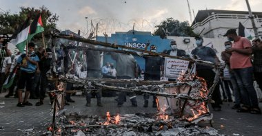 Palestinian demonstrators burn symbolic coffins during a demonstration in front of the office of the United Nations Special Coordinator for the Middle East Peace Process (UNSCO) in Gaza, against the U.S.-brokered Israeli normalization agreements with the United Arab Emirates and Bahrain, hours ahead of the signing ceremony at the White House, Palestine, Sept. 15, 2020. (Photo by Getty Images)