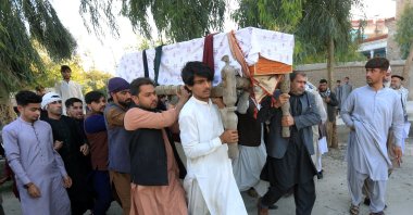 A group of people carry the coffin of one of three female polio vaccination health workers who were shot and killed by unknown gunmen, during a burial ceremony in Jalalabad, Afghanistan, March 30, 2021. (Reuters Photo)