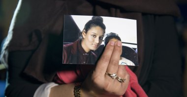 Renu Begum, the eldest sister of Shamima Begum, 15, holds her sister's photo as she is interviewed by the media at New Scotland Yard, London, U.K., Feb. 22, 2015. (Photo by Getty Images)