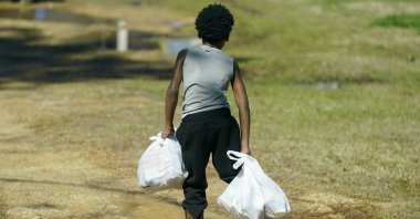 A Jefferson County student carries several days of breakfasts and lunches back to his home, in Fayette, Mississippi, U.S., March 3, 2021. (AP Photo)