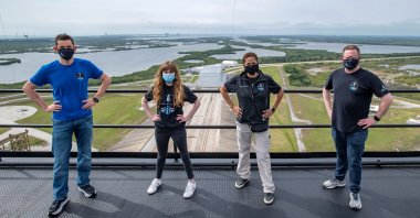 (L-R) Jared Isaacman, Hayley Arceneaux, Sian Proctor and Chris Sembroski pose for a photo at the SpaceX launch tower at NASA's Kennedy Space Center at Cape Canaveral, Florida, U.S., March 29, 2021. (SpaceX Handout via Reuters)