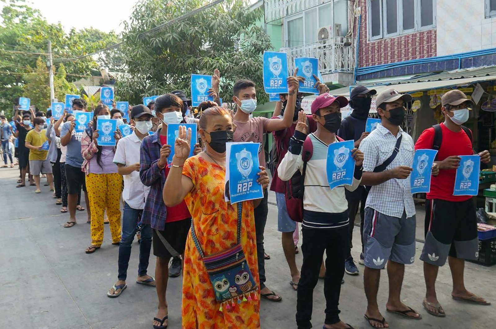 Protesters hold signs relating to "R2P," or the "Responsibility to Protect" principle that the international community should take action against a state that has failed to protect its population, in Yangon's Thaketa township, Myanmar, April 1, 2021. (AFP Photo)