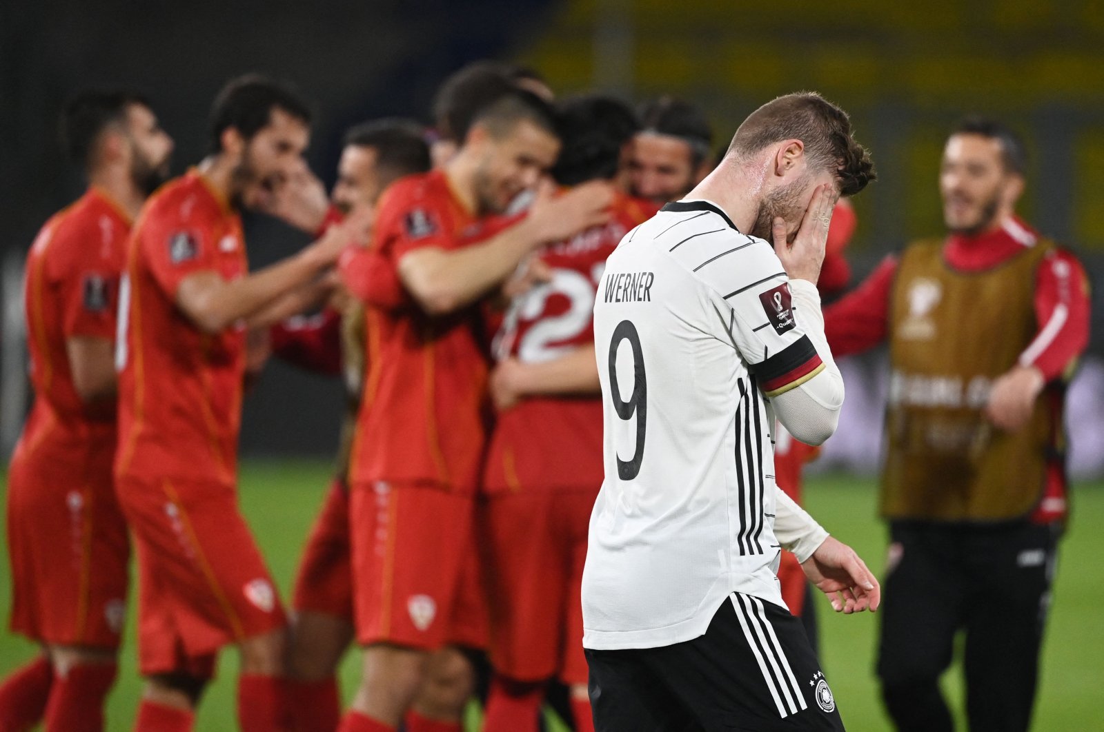 North Macedonia players celebrate as Germany's forward Timo Werner walks past after the FIFA World Cup Qatar 2022 qualification Group J match in Duisburg, western Germany, March 31, 2021. (AFP Photo)