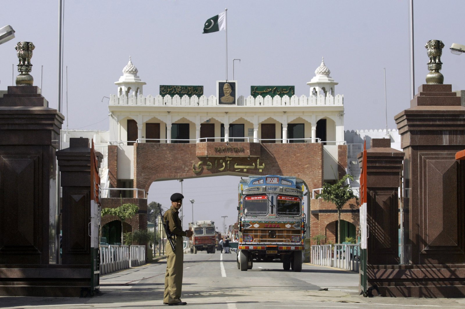 An Indian border security force soldier stands guard as an Indian truck, exporting goods to Pakistan, returns back towards the Indian side of a joint check post between India and Pakistan at Wagah, India, Feb. 26, 2009. (AP Photo)