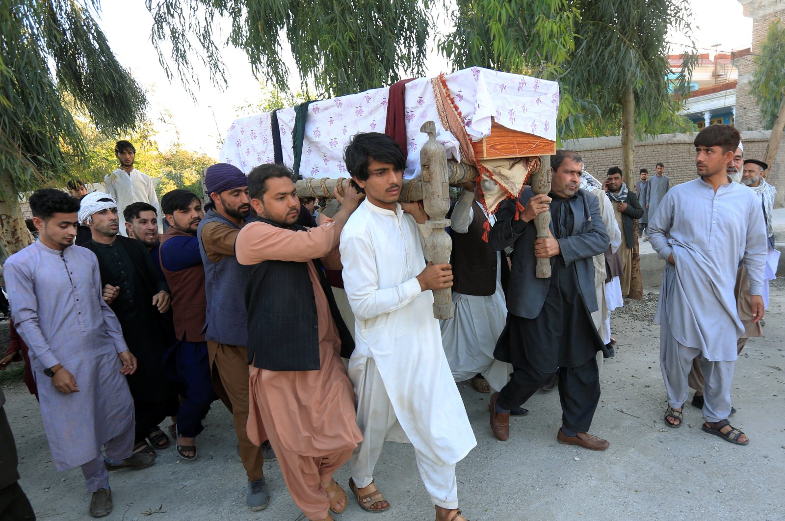 A group of people carry the coffin of one of three female polio vaccination health workers who were shot and killed by unknown gunmen, during a burial ceremony in Jalalabad, Afghanistan, March 30, 2021. (Reuters Photo)