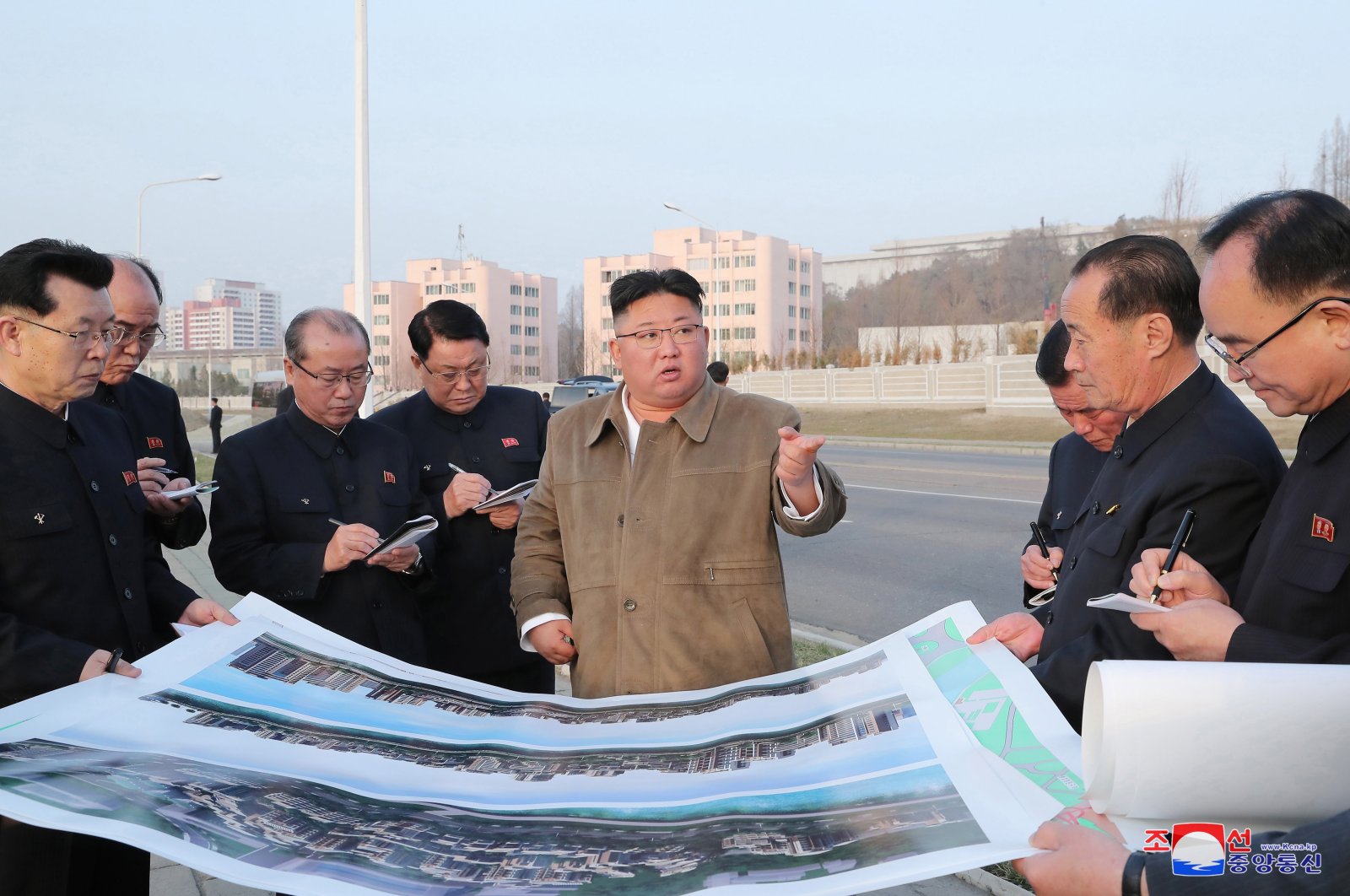 North Korean leader Kim Jong Un (C) visites the construction site for terraced apartment buildings along the Pothong River in North Korea, April 1, 2021. (EPA Photo)
