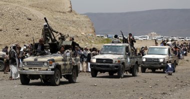 Tribespeople loyal to the Houthis ride trucks mounted with machine guns during an armed tribal gathering on the outskirts of Sanaa, Yemen, July 8, 2020. (Photo by Getty Images)