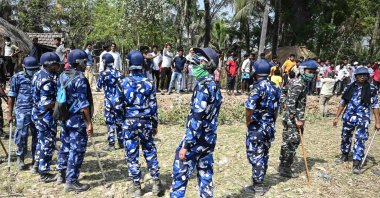 Rapid Action Force (RAF) stand guard between All India Trinamool Congress party supporters and Bharatiya Janata Party (BJP) supporters as West Bengal's Chief Minister Mamata Banerjee (not pictured) enters a polling station during the second phase of West Bengal's legislative elections in Nandigram, India, April 1, 2021. (AFP Photo)