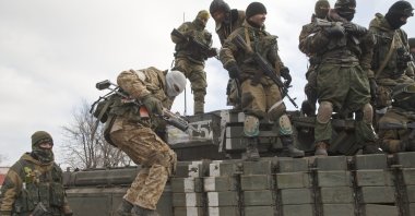 A Russia-backed rebel jumps off a tank in Debaltseve, Ukraine, Feb. 20, 2015. (AP Photo)
