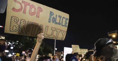 Protesters decry the death of George Floyd, Michael Ramos and police brutality against black Americans in front of the Austin Police Department headquarters in Austin, Texas, U.S., June 5, 2020. (Austin American-Statesman via AP)