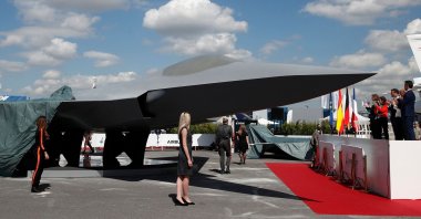 In this file photo taken on June 17, 2019, French President Emmanuel Macron, Eric Trappier, chairperson and CEO of Dassault Aviation, Spanish Defense Minister Margarita Robles, French Defense Minister Florence Parly and German Defense Minister Ursula von der Leyen attend the unveiling of the full-scale jet fighter model of the French-German-Spanish new generation Future Combat Air System (FCAS), during the 53rd International Paris Air Show at Le Bourget Airport near Paris, France. (AFP Photo)