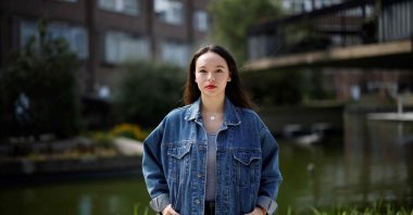 Creator of the website "Everyone's Invited," Soma Sara poses during an interview with AFP at The Water Gardens in Westminster, central London, U.K., April 4, 2021. (AFP Photo)