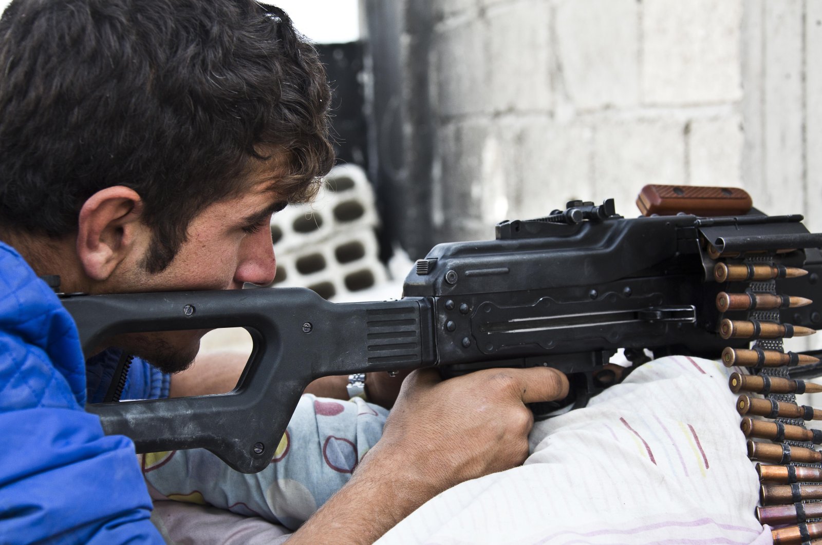 A young member of the YPG who recently volunteered for the terrorist group holds a position with his weapon in Kobani, Syria, Nov. 19, 2014. (AP Photo)