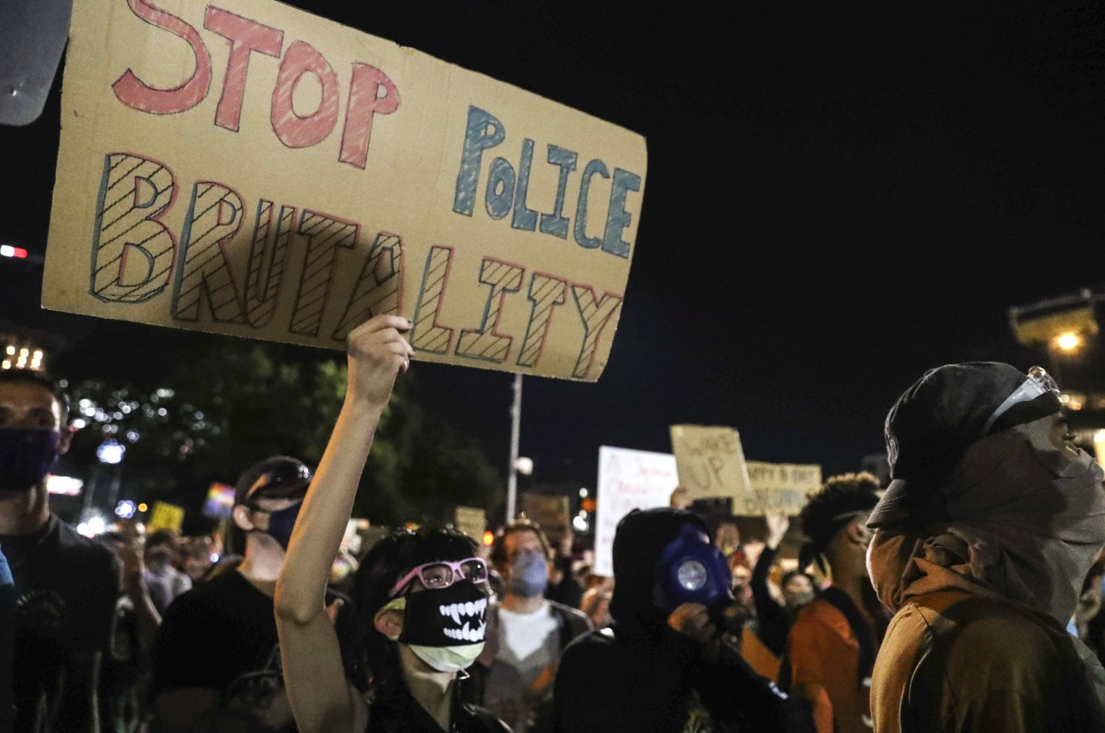 Protesters decry the death of George Floyd, Michael Ramos and police brutality against black Americans in front of the Austin Police Department headquarters in Austin, Texas, U.S., June 5, 2020. (Austin American-Statesman via AP)