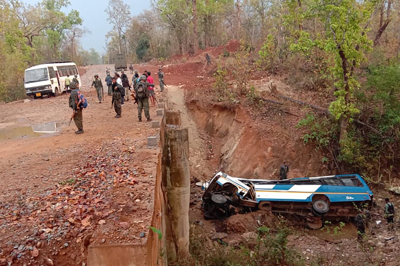 Security officers patrol the site of a bombing in the Narayanpur district of Chhattisgarh state, India, Tuesday, March 23, 2021. (AP Photo)