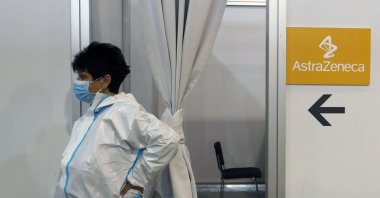 A medical worker wearing protective gear waits for people to receive the COVID-19 vaccine at a vaccination center in Belgrade, Serbia, March 23, 2021. (AP Photo)
