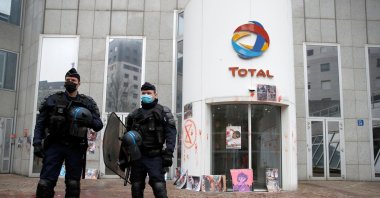Police stand in front of Total's headquarters after an Extinction Rebellion protest for Myanmar's military coup victims, in La Defense business district, near Paris, France, March 25, 2021. (Reuters Photo)