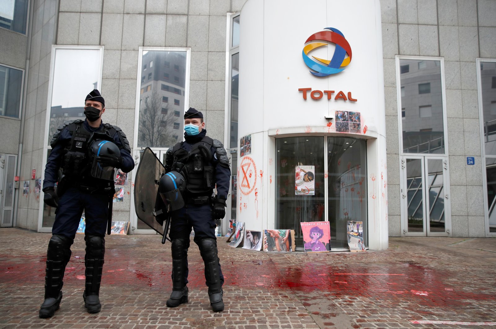 Police stand in front of Total's headquarters after an Extinction Rebellion protest for Myanmar's military coup victims, in La Defense business district, near Paris, France, March 25, 2021. (Reuters Photo)
