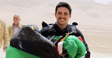 Jordanian Prince Hamza bin Al Hussein carries a parachute during a media event to announce the launch of "Skydive Jordan," in the Wadi Rum desert, Jordan, April 17, 2012. (AFP Photo)