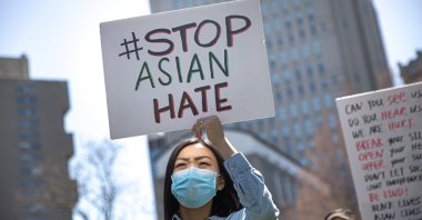 A woman holds a placard as she participates in a “Stop Asian Hate” rally at Columbus Park in New York City, U.S., April 3, 2021. (Reuters)