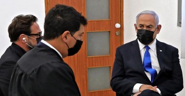 Israeli Prime Minister Benjamin Netanyahu (R) attends the hearing for his corruption trial at district court in Jerusalem on April 5, 2021. (AFP Photo)