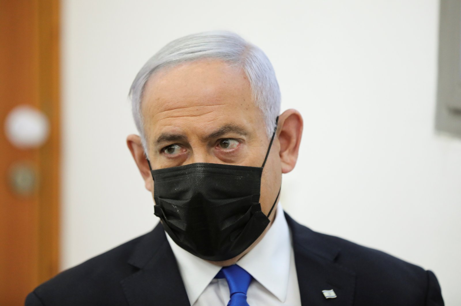 Israeli Prime Minister Benjamin Netanyahu, wearing a face mask, looks on as his corruption trial resumes, at Jerusalem's District Court, Israel, April 5, 2021. (Abir Sultan/Pool via REUTERS)