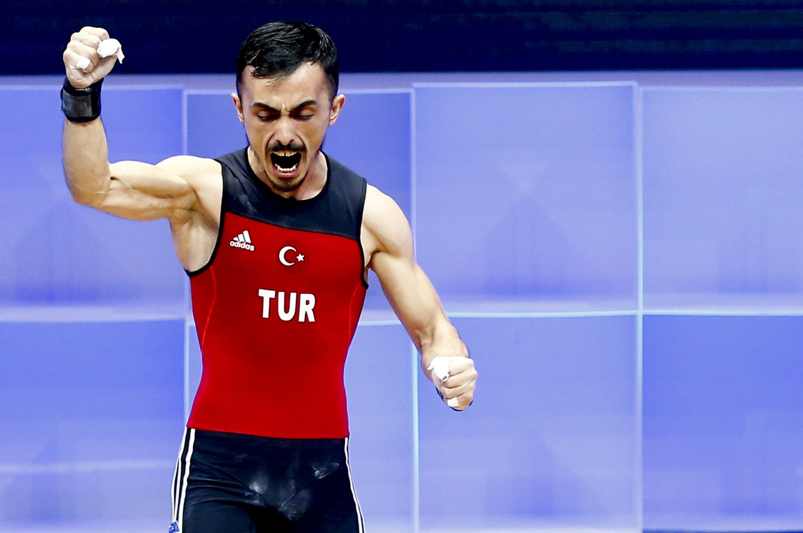 Turkey's Muammer Şahin celebrates after his turn in the men's 55-kilogram weight class final at the Weightlifting European Championships 2021 in Moscow, Russia, April 4, 2021. (AA Photo)