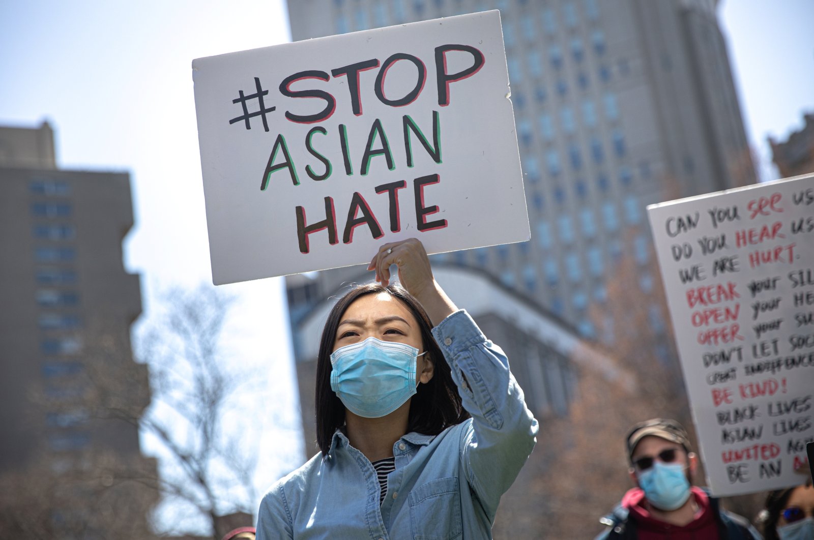 A woman holds a placard as she participates in a “Stop Asian Hate” rally at Columbus Park in New York City, U.S., April 3, 2021. (Reuters)