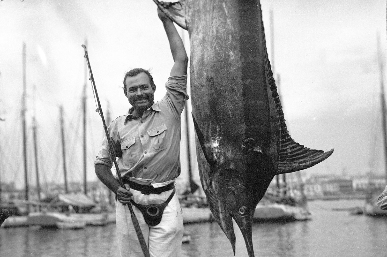 In this July 1934 photo provided by the John F. Kennedy Library Foundation, Ernest Hemingway poses with a marlin at Havana Harbor, in Key West, Florida, U.S. (AP Photo)