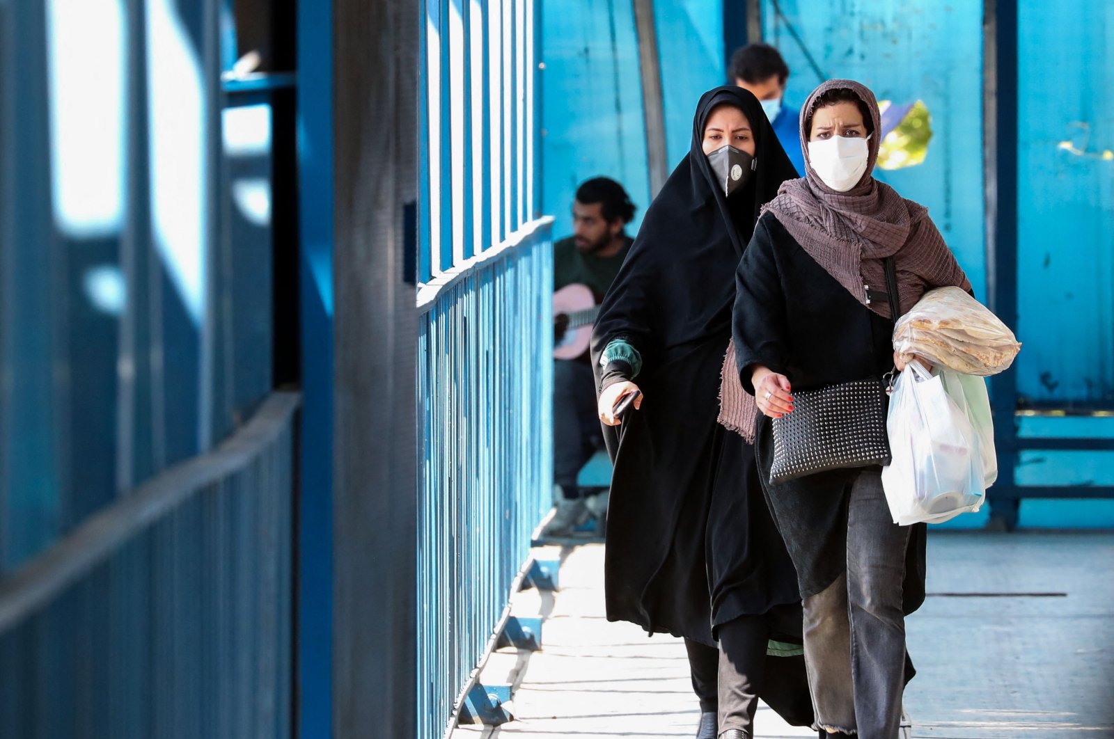 Women wearing protective masks amid the coronavirus pandemic walk by in Iran's capital Tehran, on April 5, 2021. (AFP Photo)