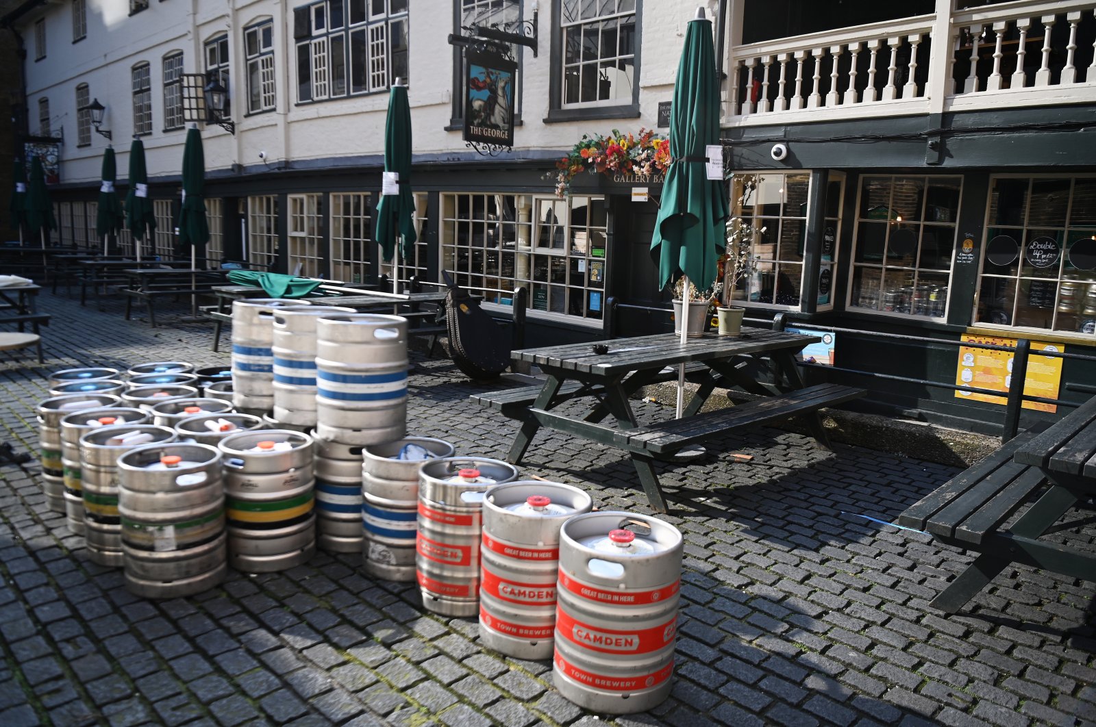 Beer kegs wait outside a pub in the City of London in London, Britain, March 22, 2021.  (EPA/ANDY RAIN)