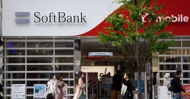 Pedestrians walk past a SoftBank mobile shop in the Ginza shopping district in Tokyo, Japan, April 6, 2021. (AFP Photo)