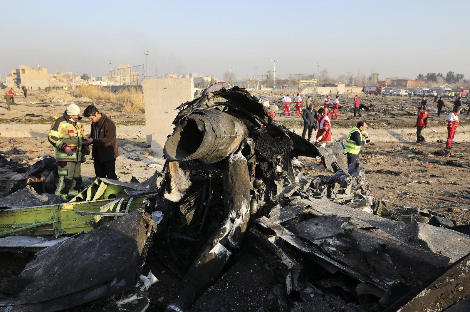 Investigators inspect the debris at the scene where the Ukrainian plane crashed after being shot down in Shahedshahr southwest of the capital Tehran, Iran, Jan. 8, 2020. (AP Photo)