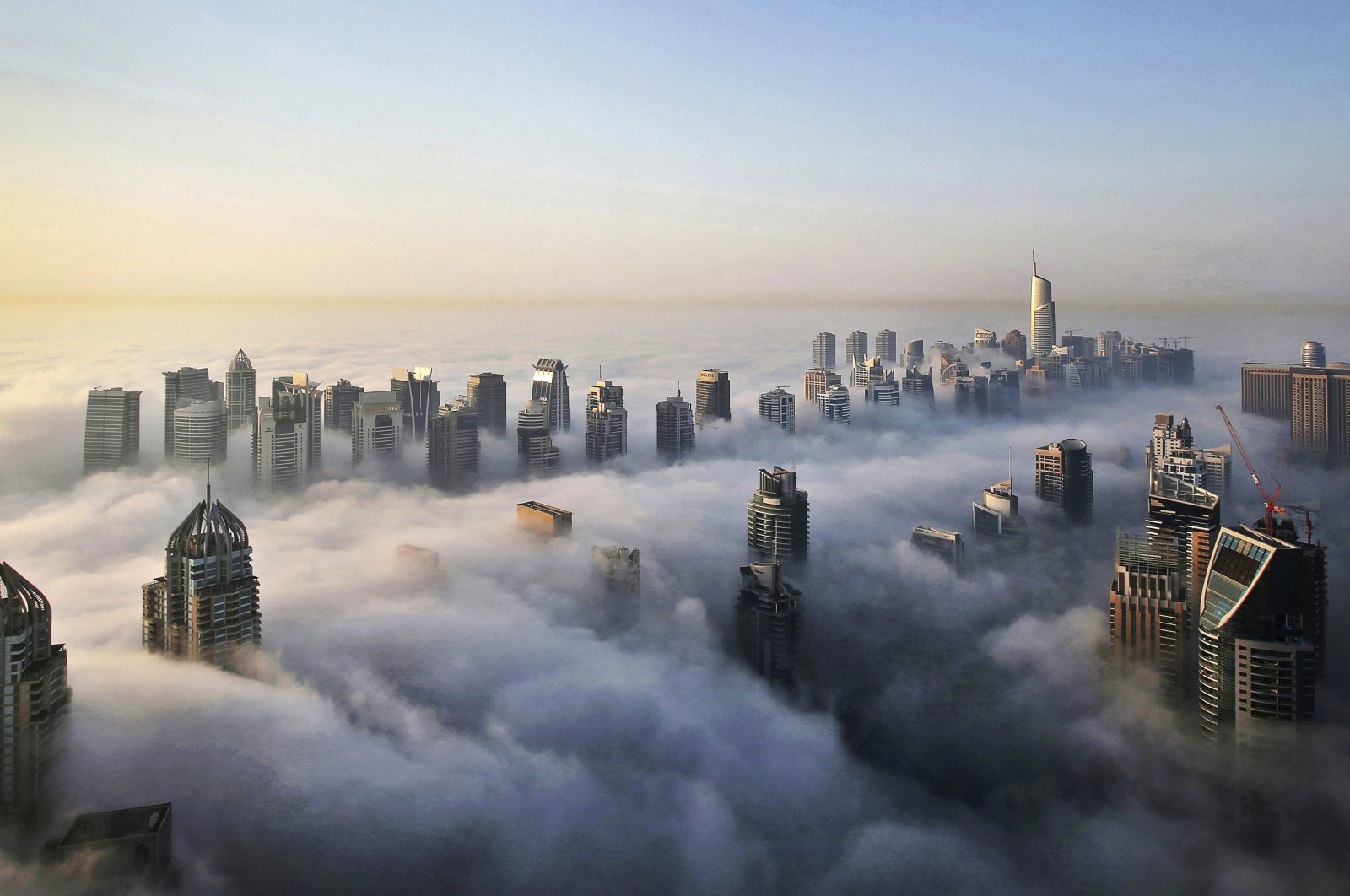 A thick blanket of early morning fog partially shrouds the skyscrapers of the Marina and Jumeirah Lake Towers districts of Dubai, United Arab Emirates, Oct. 5, 2015. (AP Photo)