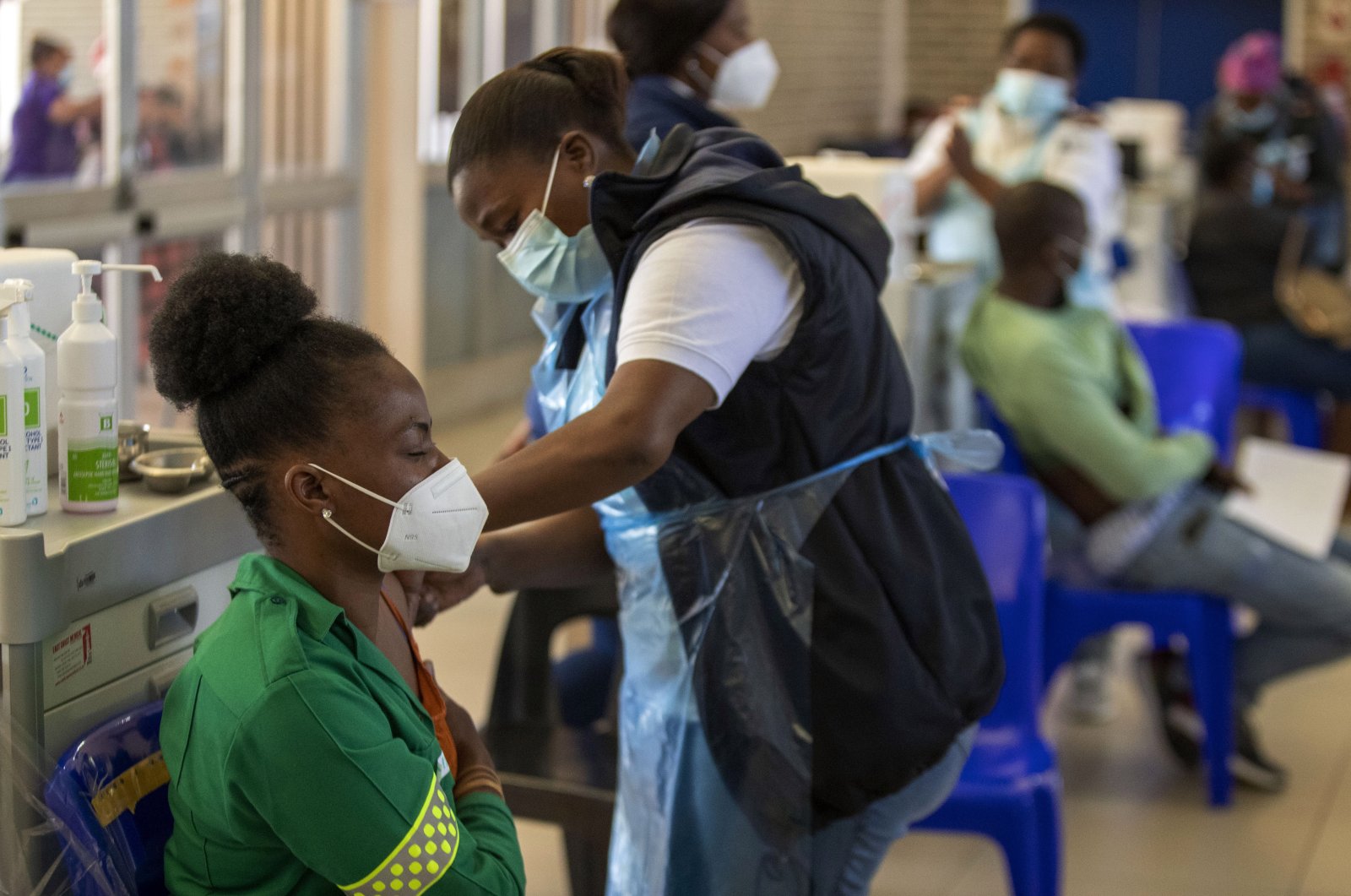 Khensani Chauke, a professional paramedic, receives a dose of Johnson & Johnson's COVID-19 vaccine from a health staff member during a vaccination day for health care workers at a vaccination center at Chris Hani Baragwanath Academic Hospital in Johannesburg, South Africa, March 26, 2021. (AP Photo)