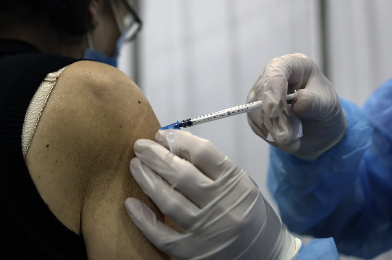 A woman receives a Pfizer-BioNTech COVID-19 vaccine at Saint George Hospital University Medical Center, Beirut, Lebanon, Tuesday, April 6, 2021. (AP Photo)
