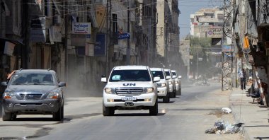 A convoy of United Nations vehicles carrying a team of U.N. chemical weapons experts and escorted by Free Syrian Army fighters drive through one of the sites of an alleged chemical weapons attack in eastern Ghouta in Damascus suburbs, Syria, Aug. 28, 2013. (Reuters Photo)