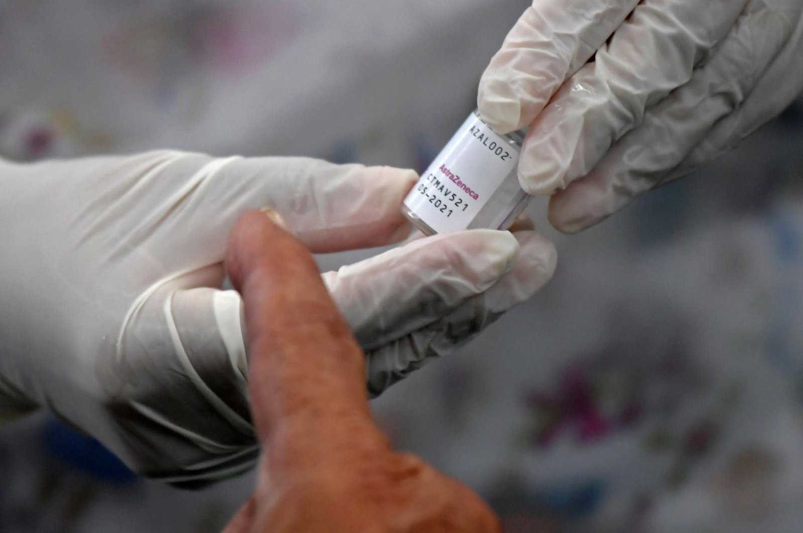 A health worker prepares an Oxford/AstraZeneca vaccine against COVID-19 as people wait amid the coronavirus pandemic, Bogota, Colombia April 7, 2021. (Photo by Raul ARBOLEDA / AFP)