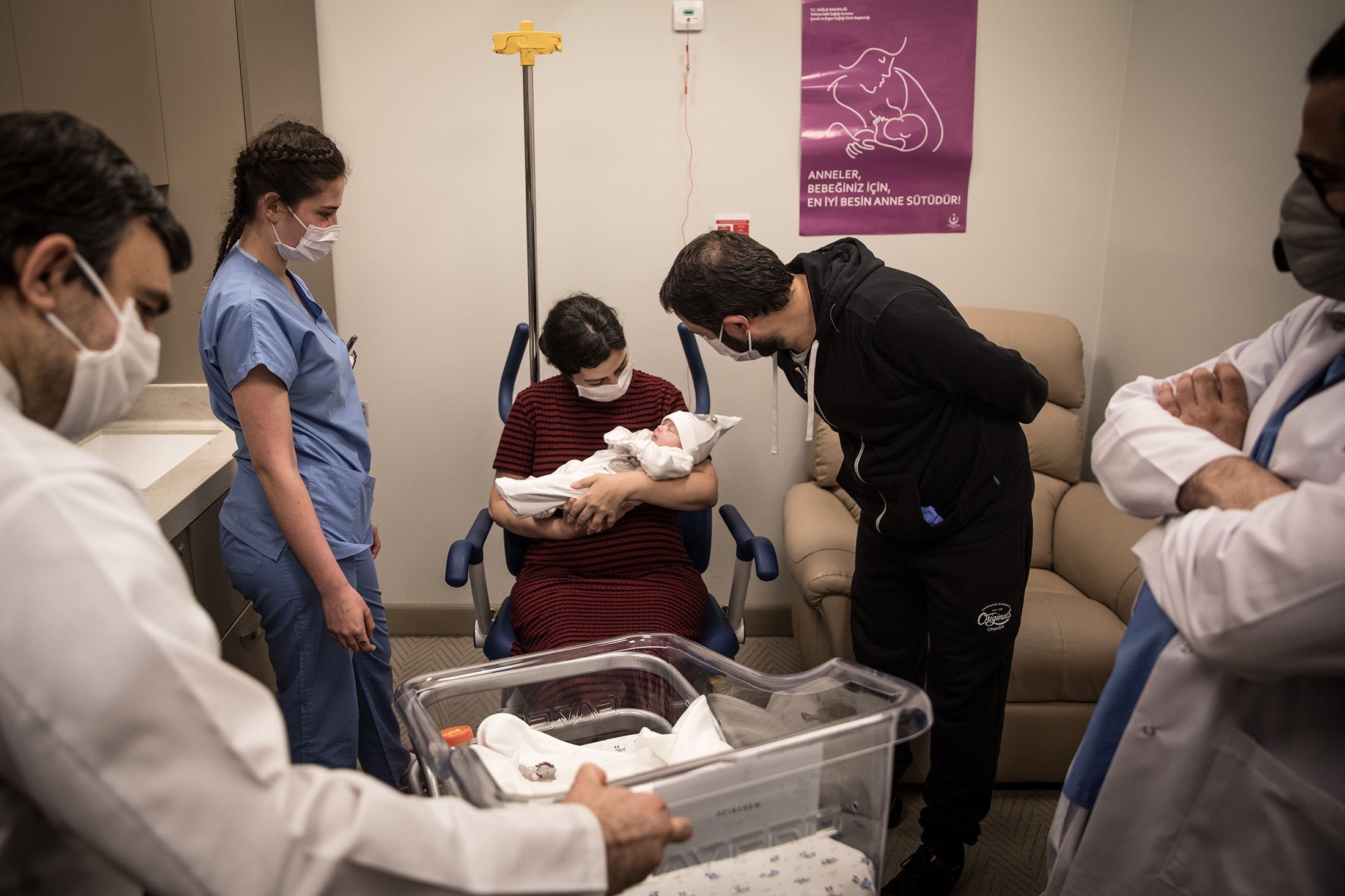 A Turkish couple welcomes their newborn baby boy for the first time after recovering from COVID-19 and being discharged from the ward on May 05, 2020 in Istanbul, Turkey. (Getty Images)