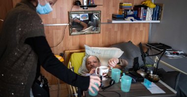 Alain Cocq, suffering from an incurable disease, lays in his medical bed at his home in Dijon, France, April 6, 2021. (AFP Photo)
