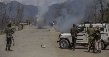 Indian police fire tear gas shells at Kashmiri villagers as they throw stones and bricks at them during a protest near the site of a gunbattle in Pulwama, south of Srinagar, Indian-controlled Kashmir, April 2, 2021. (AP Photo)