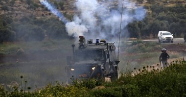 Tear gas is fired by Israeli forces against Palestinian protesters during clashes in the village of al-Mughayer near the Israeli-occupied West Bank city of Ramallah, April 2, 2021. (AFP Photo)