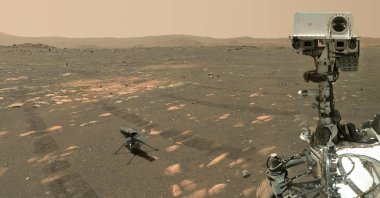 The Perseverance Mars rover in a selfie taken with the WATSON (Wide Angle Topographic Sensor for Operations and eNgineering) camera with the Ingenuity helicopter, seen here about 13 feet (3.9 meters) from the rover, on the 46th Martian day, or sol, of the mission, or April 6, 2021. (Photo by Handout / NASA/JPL-Caltech/MSSS / AFP)