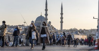 People wearing protective face masks walk on Galata bridge during the coronavirus disease (COVID-19) pandemic, Istanbul, Turkey, Nov. 16, 2020. (Getty Images)