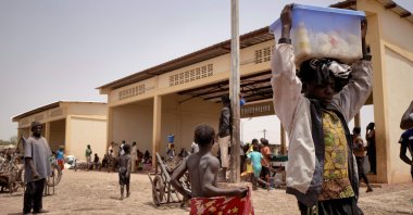 A child sells milk at the port of Mopti, Mali, West Africa, March 19, 2021. (AFP Photo)